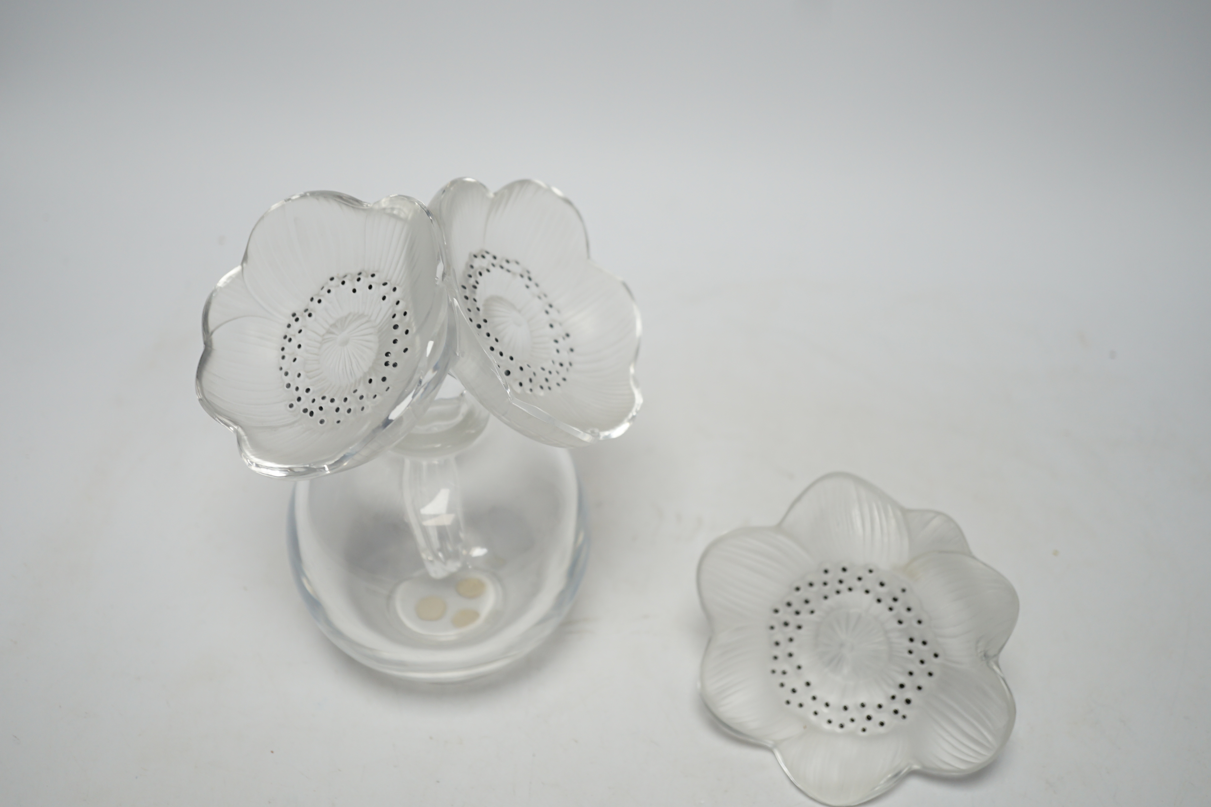 A Lalique anemone glass scent bottle and stopper, signed to the base, together with an associated anemone stopper, 16cm high